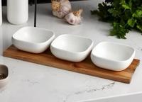 Set includes three matching bowls and acacia tray